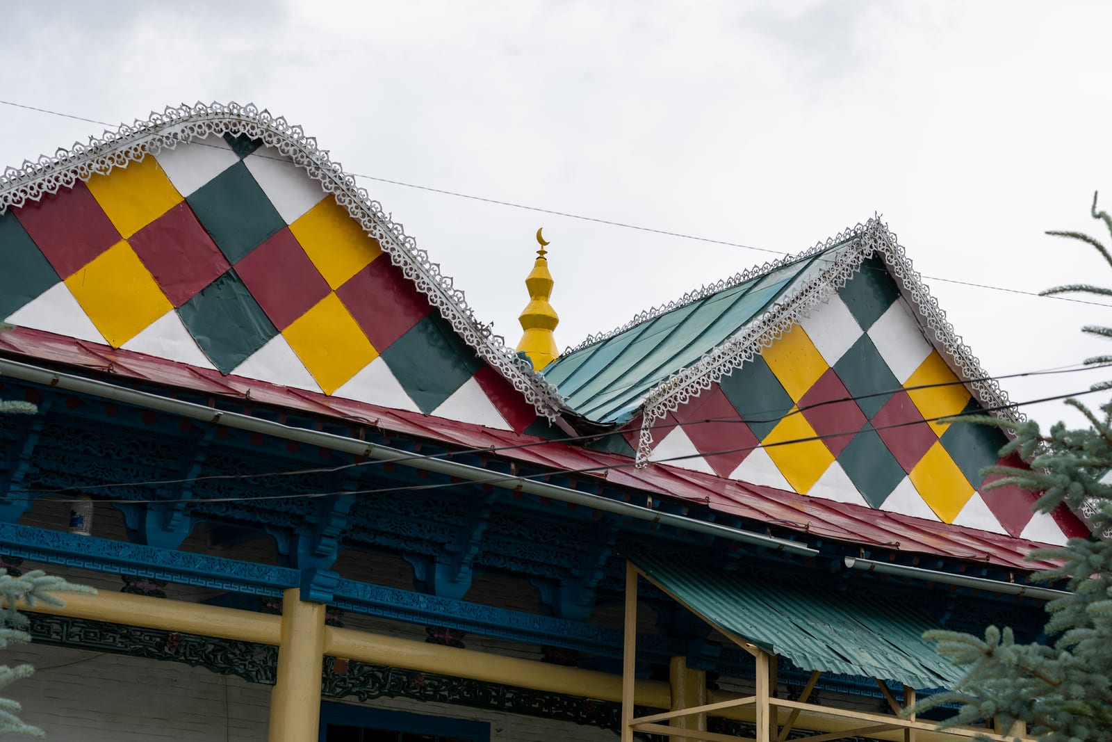 Colourful checkerboard gables and painted eaves of the wooden Dungan mosque