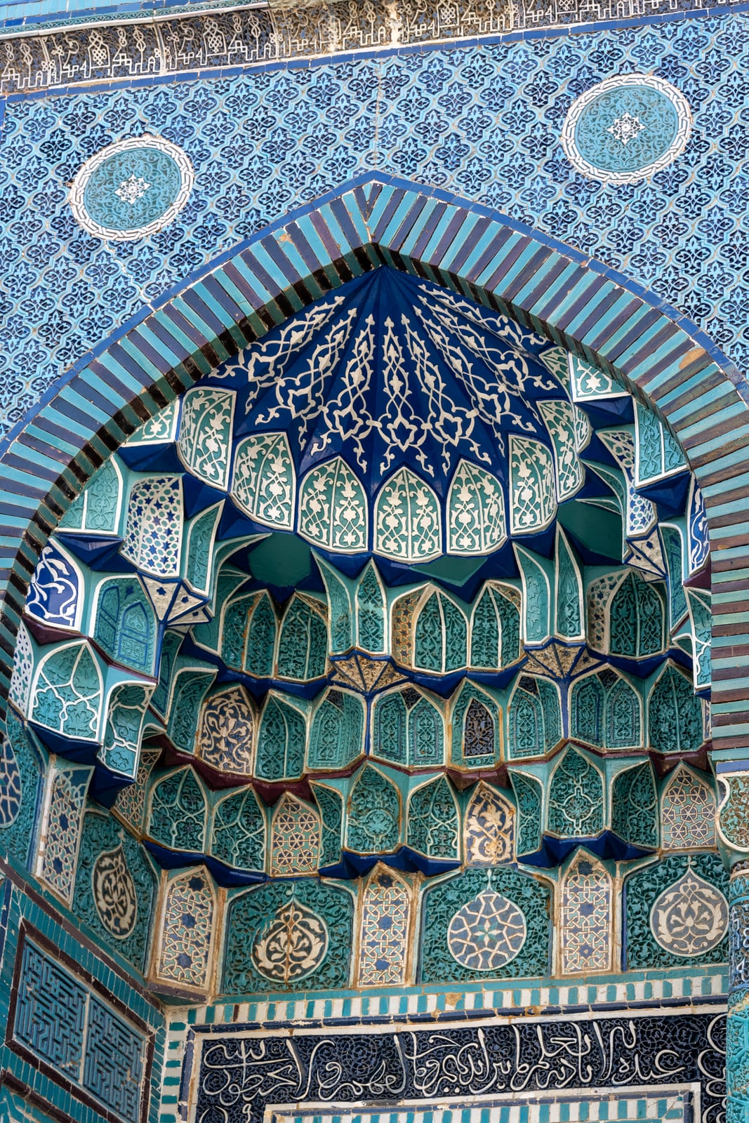 Turquoise and navy muqarnas vault of a Shah-i-Zinda portal seen from below