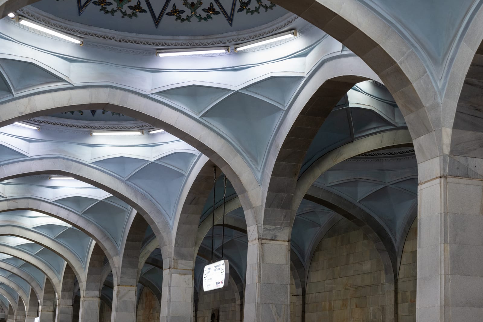 White vaulted arches and domes of a metro station ceiling