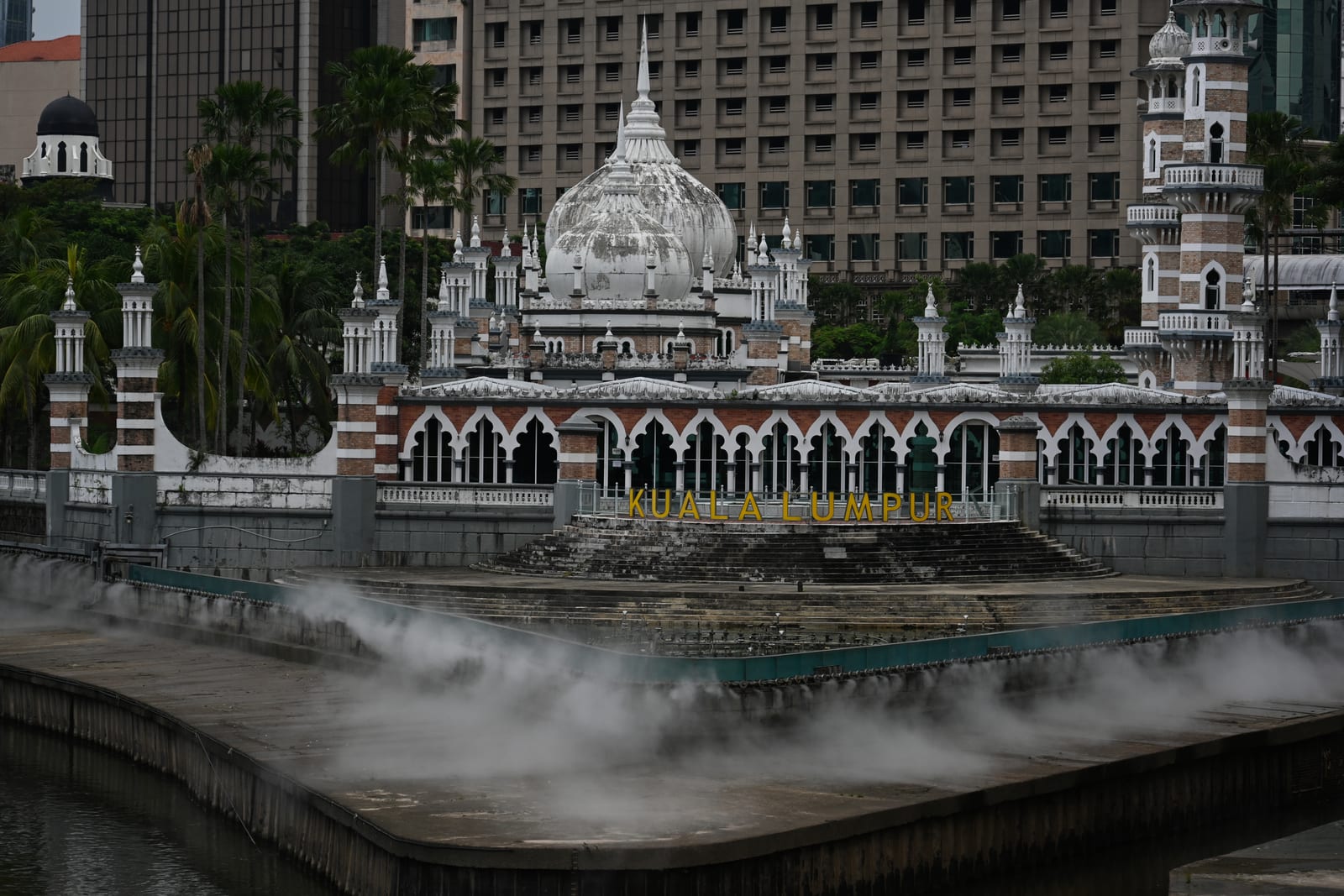 Masjid Jamek at the river confluence with mist rising off the water